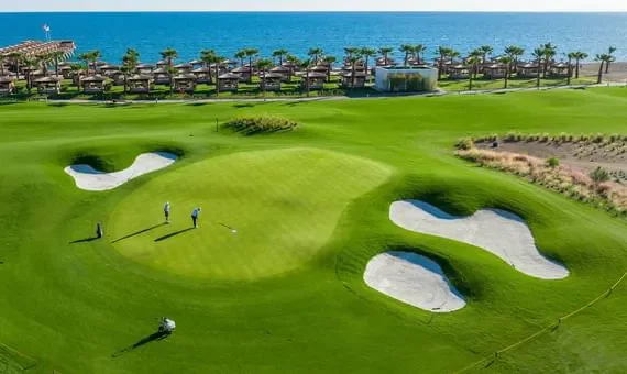 Aerial view of a greenery golf course field at Titanic Luxury Collection Bodrum